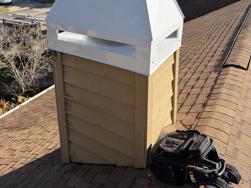 Chimney inspection revealing deteriorating wood siding and new metal cap installation in FL